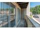 Balcony view with wood floors and access to the parking lot through a sliding glass door at 1614 Arlyn Cir, Charlotte, NC 28213