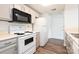 Bright kitchen with stainless steel microwave, updated cabinets, and modern appliances at 1614 Arlyn Cir, Charlotte, NC 28213