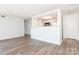 Spacious living room featuring new wood-look flooring and an open kitchen concept at 1614 Arlyn Cir, Charlotte, NC 28213