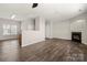 Hardwood floor living room with kitchen view, fireplace and ceiling fan at 19531 Deer Valley Dr, Cornelius, NC 28031