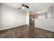 Open-concept living room with wood floors seamlessly flows into a kitchen with stainless steel appliances at 19531 Deer Valley Dr, Cornelius, NC 28031