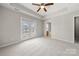 Spacious main bedroom with tray ceiling and double doors leading to a balcony at 19531 Deer Valley Dr, Cornelius, NC 28031