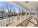 Inviting porch with wood flooring and white railing overlooking a residential street at 19531 Deer Valley Dr, Cornelius, NC 28031