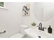 Elegant powder room with a round mirror, black faucet, and stylish decor at 2117 Gemway Dr, Charlotte, NC 28216