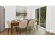 Elegant dining area with a table set for six, bright lighting, and sliding glass doors at 2117 Gemway Dr, Charlotte, NC 28216