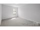 Bright bedroom features neutral walls, carpet, and a window providing natural light at 2302 E Main St # 1P, Albemarle, NC 28001