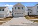 Charming two-story home with gray siding, a two-car garage, and well-maintained landscaping at 2302 E Main St # 1P, Albemarle, NC 28001