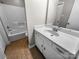 Bathroom features a single sink vanity with ceramic tile flooring and a shower-tub combo at 2507 Kilborne Dr # H, Charlotte, NC 28205