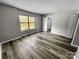 Well-lit bedroom featuring vinyl floors, closet, and large window with outside view at 2507 Kilborne Dr # H, Charlotte, NC 28205