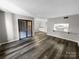Bright and airy living room with a view of the kitchen and deck, vinyl floors, and abundant natural light at 2507 Kilborne Dr # H, Charlotte, NC 28205