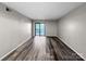 Minimalist room with sliding glass doors to outdoor space and sleek vinyl floors at 2507 Kilborne Dr # H, Charlotte, NC 28205