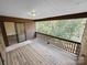 View of a wooden porch with railing and sliding doors leading inside, showing outdoor living space at 2507 Kilborne Dr # H, Charlotte, NC 28205