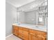 Bathroom features a double sink vanity with wood cabinets and a large mirror with decorative lighting at 2913 Ashley Woods Ct, Monroe, NC 28112