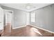 Bedroom showcases hardwood floors, neutral walls, a ceiling fan, and a window with natural light at 2913 Ashley Woods Ct, Monroe, NC 28112