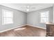 Bedroom boasts hardwood floors, neutral walls, a ceiling fan, and natural light from two windows at 2913 Ashley Woods Ct, Monroe, NC 28112