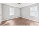 Bright bedroom with two windows allowing for an abundance of natural light and hardwood flooring at 2913 Ashley Woods Ct, Monroe, NC 28112