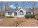 Charming single-story home featuring a well-manicured lawn, gray siding, and a classic roofline at 2913 Ashley Woods Ct, Monroe, NC 28112