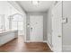 Bright foyer featuring hardwood floors, front door, and entryway to kitchen at 2913 Ashley Woods Ct, Monroe, NC 28112