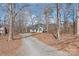 Inviting single-story home with mature trees, long driveway, and well-maintained landscaping at 2913 Ashley Woods Ct, Monroe, NC 28112
