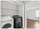 Laundry room with washer, dryer, and wire rack shelving for optimal storage at 2913 Ashley Woods Ct, Monroe, NC 28112