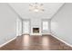 Bright living room featuring hardwood floors, a fireplace, and a ceiling fan at 2913 Ashley Woods Ct, Monroe, NC 28112