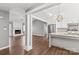 Open-concept living space with hardwood floors, fireplace, and stainless steel appliances at 2913 Ashley Woods Ct, Monroe, NC 28112