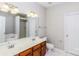 Bathroom with dual sinks, cherry cabinets, and a separate tub and shower at 307 Rose Garden Ct, Rock Hill, SC 29732