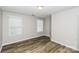Comfortable bedroom with wood-look floors and two bright windows at 307 Rose Garden Ct, Rock Hill, SC 29732