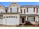 Beautiful townhome featuring a one-car garage, brick accents, and a welcoming front porch at 307 Rose Garden Ct, Rock Hill, SC 29732