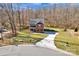 An aerial view of a beautiful red brick home with large driveway and large yard, offering a serene setting at 320 Heritage Pl, Mooresville, NC 28115