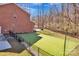A spacious backyard with lush green turf, ideal for recreation, framed by a sleek black fence at 320 Heritage Pl, Mooresville, NC 28115