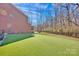 This spacious backyard has artificial turf, perfect for outdoor activities at 320 Heritage Pl, Mooresville, NC 28115