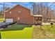 A spacious backyard featuring lush green turf, complete with an outdoor firepit and screened-in porch for outdoor enjoyment at 320 Heritage Pl, Mooresville, NC 28115