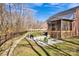 A beautiful patio with chairs and grill in the backyard, perfect for outdoor gatherings at 320 Heritage Pl, Mooresville, NC 28115