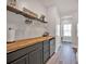 Modern bar area featuring a wooden countertop, gray cabinets, wine glass rack, and stylish decor at 320 Heritage Pl, Mooresville, NC 28115
