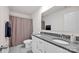 Bathroom featuring dual sinks with granite countertops, white cabinets, and a shower with a curtain at 320 Heritage Pl, Mooresville, NC 28115