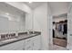 Modern bathroom with dual sinks, granite countertops, white cabinets, and a walk-in closet at 320 Heritage Pl, Mooresville, NC 28115