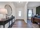 Inviting entryway with console table, decorative mirror, and natural light at 320 Heritage Pl, Mooresville, NC 28115