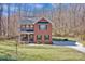 Charming two-story red brick home with a welcoming front porch and manicured lawn at 320 Heritage Pl, Mooresville, NC 28115