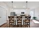 Bright kitchen featuring white cabinets, granite countertops, and stainless steel appliances with a breakfast bar at 320 Heritage Pl, Mooresville, NC 28115