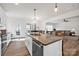 Well-lit kitchen with a center island, stainless steel appliances, and adjacent dining area, ideal for entertaining at 320 Heritage Pl, Mooresville, NC 28115