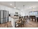 Open-concept kitchen featuring an island, stainless steel appliances, and connection to the dining area at 320 Heritage Pl, Mooresville, NC 28115