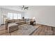 Bright living room features hardwood floors, neutral tones, and a comfortable sectional sofa at 320 Heritage Pl, Mooresville, NC 28115