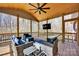 Relax on this covered porch with comfortable seating and a ceiling fan at 320 Heritage Pl, Mooresville, NC 28115