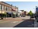 A charming street with brick buildings featuring awnings and various storefronts evokes a welcoming town atmosphere at 320 Heritage Pl, Mooresville, NC 28115