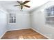 Bedroom featuring wood floors, crown molding, two windows with blinds, and a ceiling fan at 3507 Sassafras Trl, Waxhaw, NC 28173
