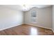 Cozy bedroom with wood flooring and large window allowing for plenty of natural light at 3507 Sassafras Trl, Waxhaw, NC 28173