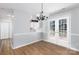 Open dining room view showing wood floors and modern chandelier at 3507 Sassafras Trl, Waxhaw, NC 28173