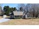 Inviting home with covered front porch, manicured landscaping, and a storage shed in a serene, tree-filled setting at 3507 Sassafras Trl, Waxhaw, NC 28173