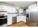 Well-lit kitchen with stainless steel appliances and white cabinetry at 3507 Sassafras Trl, Waxhaw, NC 28173